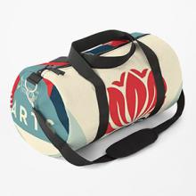 Duffle bag with black straps featuring Shepard Fairey's artwork.