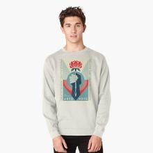 Person in a grey, long sleeved, pullover sweatshirt featuring Shepard Fairey's artwork